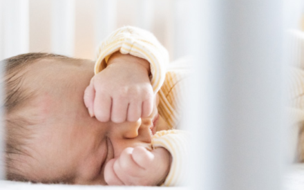 2 month old infant in crib