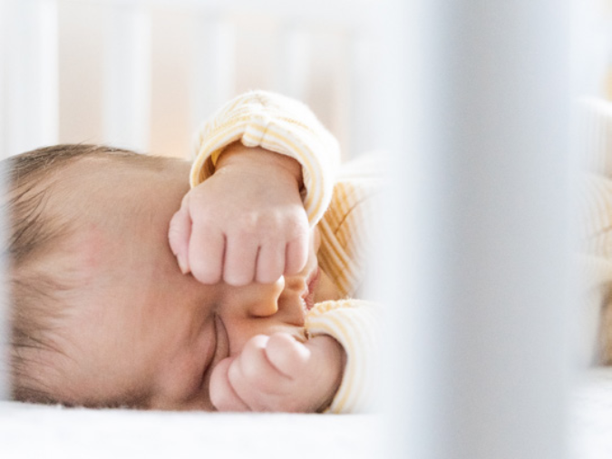 2 month old infant in crib