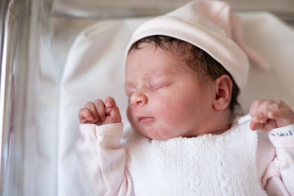 Newborn baby sleeping on back.