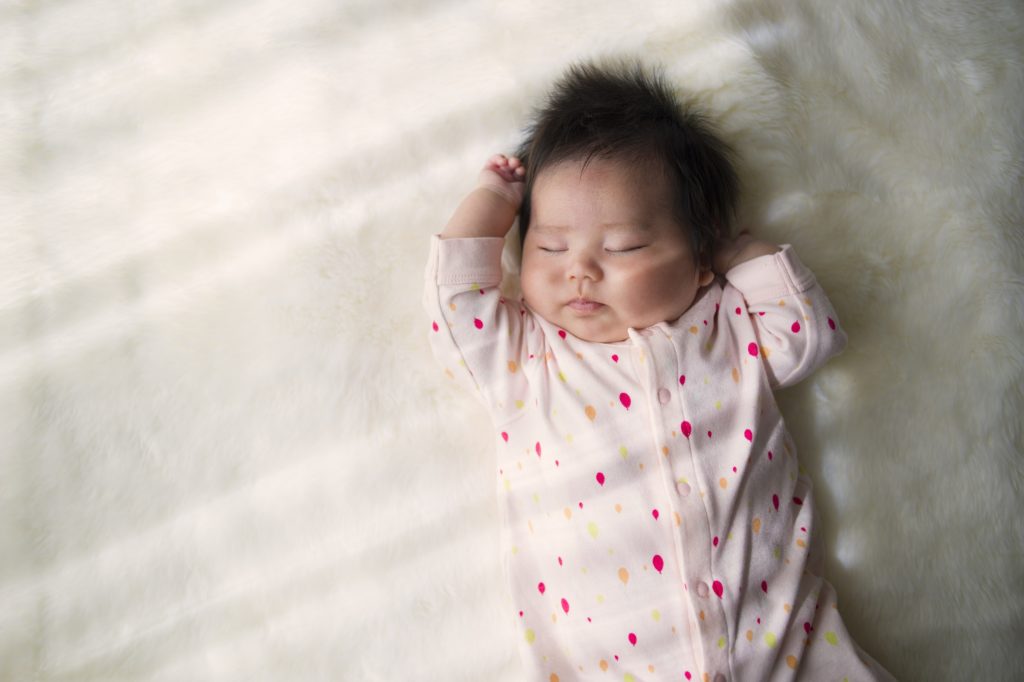 Baby sleeping on back.