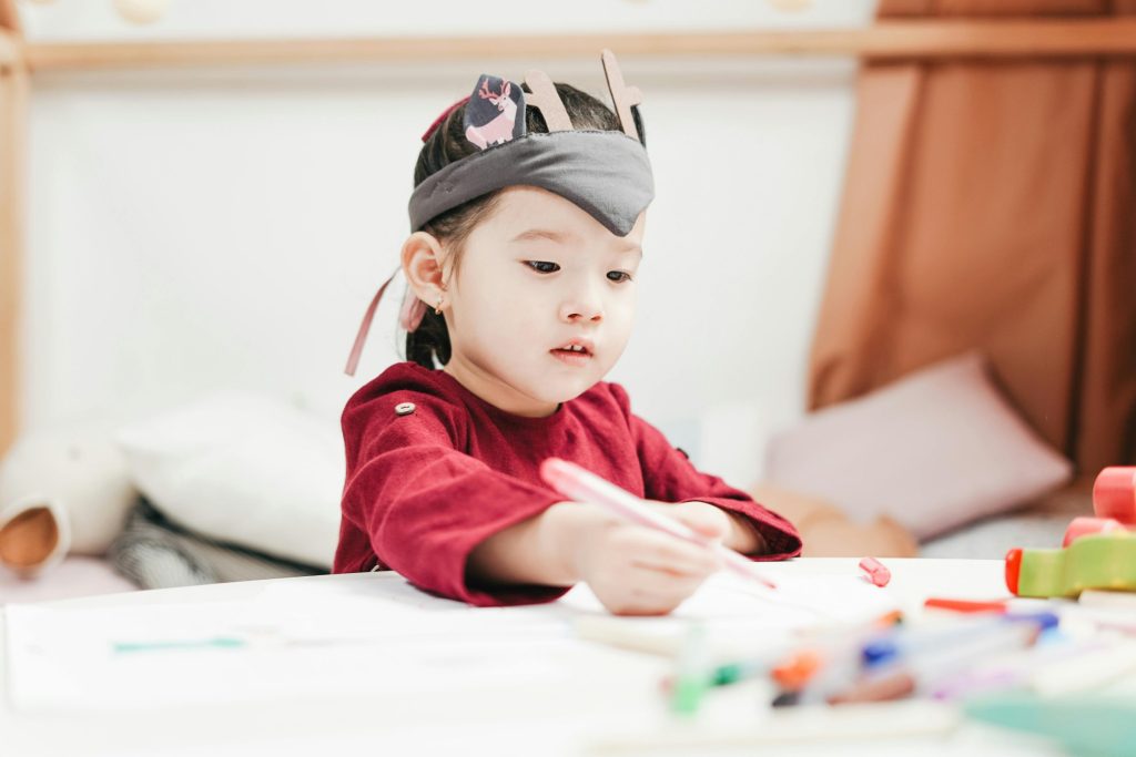 Child writing on piece of paper.