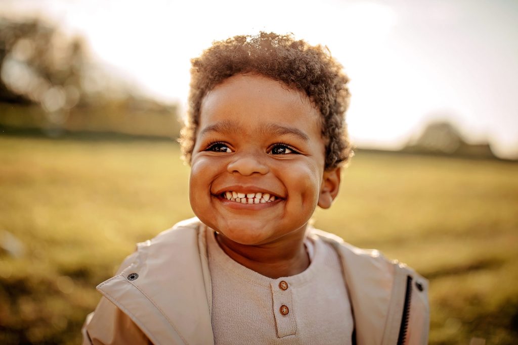 Little boy smiling widely.
