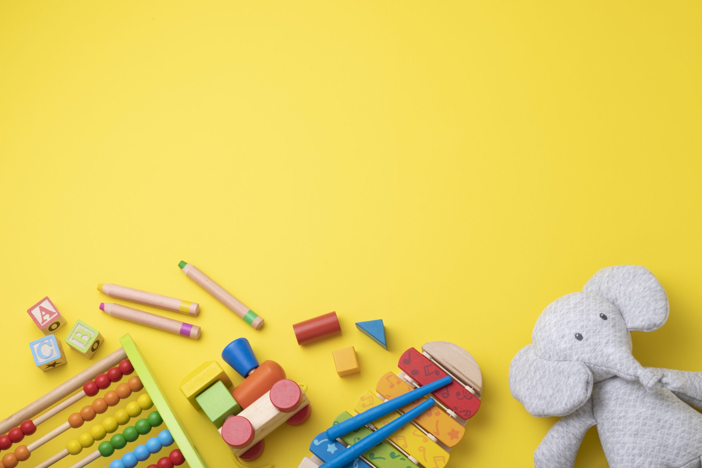 Yellow table with colorful children's toys.